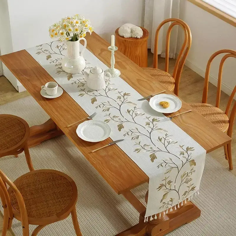 Embroidered cotton linen table runner with tassel details for dining table décor